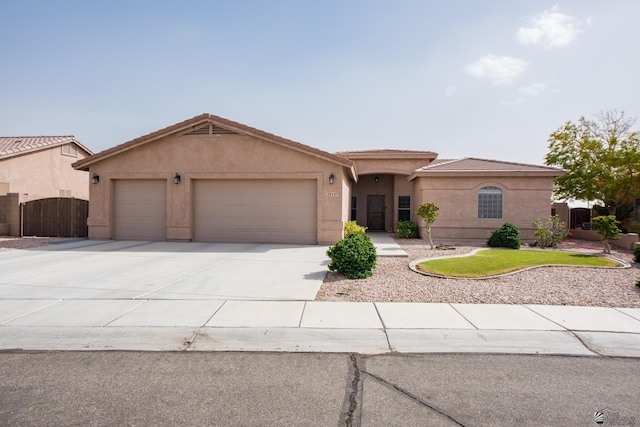 12127 E 35th St, Yuma, AZ 85367 - view of front facade with a garage, stucco siding, driveway, and a gate
