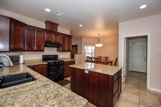 12127 E 35th St, Yuma, AZ 85367 - kitchen with stainless steel microwave, under cabinet range hood, light tile patterned floors, a sink, and black range with gas cooktop