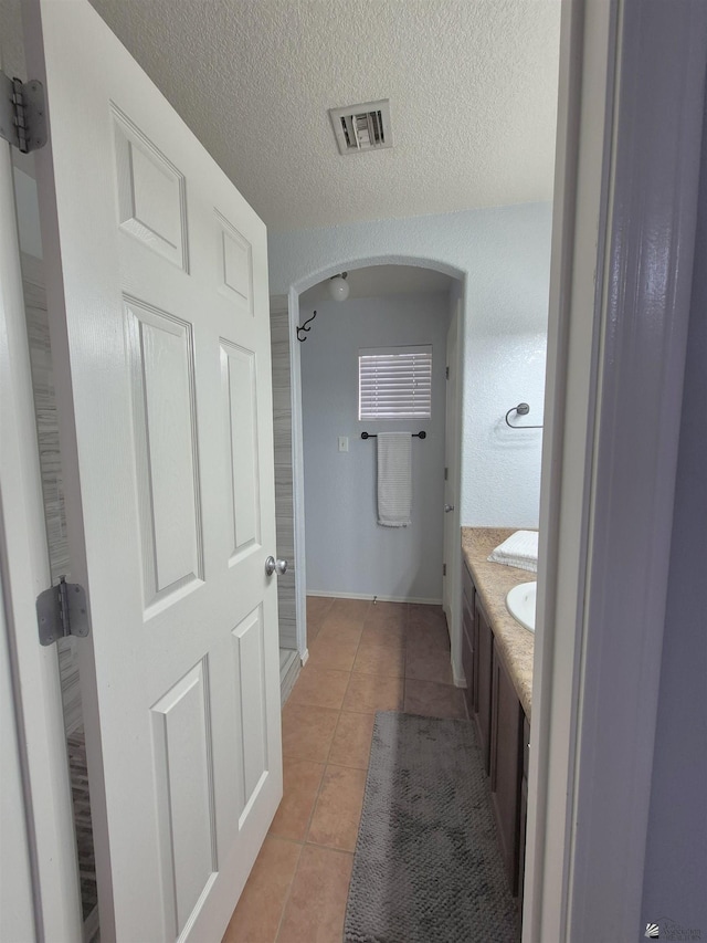 10178 S Cony Ave, Yuma, AZ 85367 - bathroom with tile patterned floors, vanity, and a textured ceiling