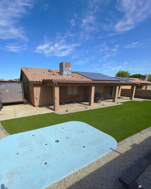 10178 S Cony Ave, Yuma, AZ 85367 - rear view of property featuring roof mounted solar panels, a patio, stucco siding, a yard, and a tiled roof