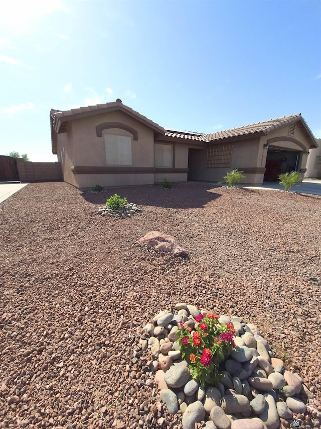 10178 S Cony Ave, Yuma, AZ 85367 - view of front facade with a tile roof, stucco siding, and fence