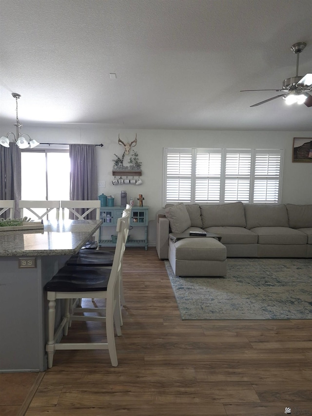 10178 S Cony Ave, Yuma, AZ 85367 - living room featuring a ceiling fan, a chandelier, wood finished floors, and a textured ceiling