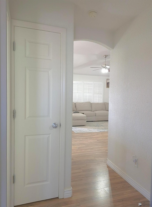 10178 S Cony Ave, Yuma, AZ 85367 - corridor featuring arched walkways, wood finished floors, and baseboards