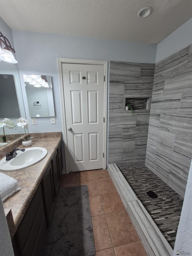 10178 S Cony Ave, Yuma, AZ 85367 - bathroom with a textured ceiling, tile patterned floors, tiled shower, and vanity