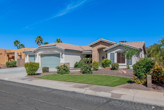 mediterranean / spanish house with a tiled roof, driveway, an attached garage, stone siding, and stucco siding