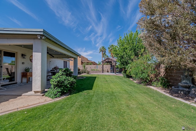 view of yard with a gazebo, a fenced backyard, and a patio area