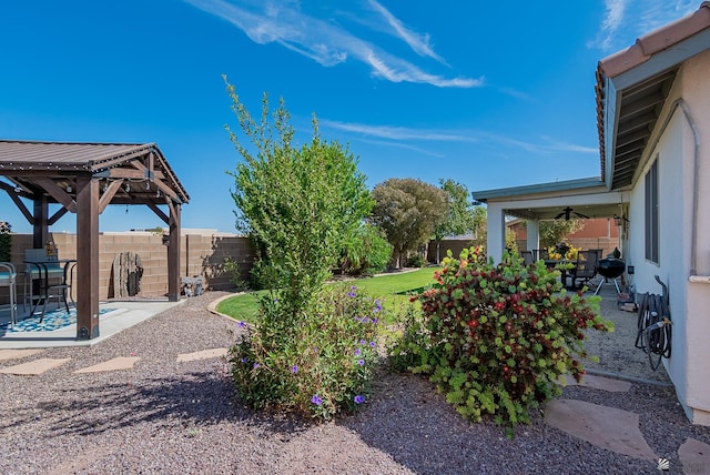 view of yard with a gazebo, a fenced backyard, and a patio