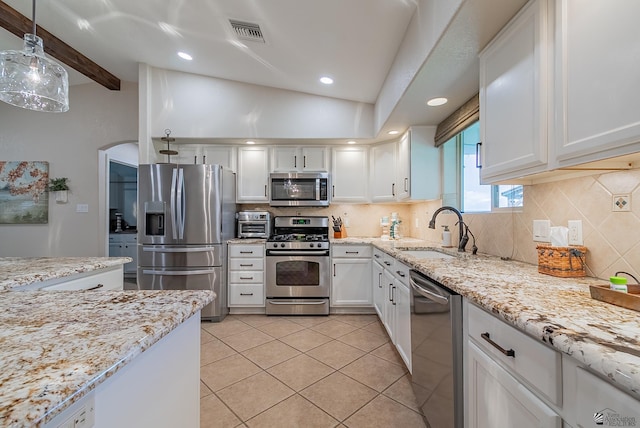 kitchen featuring visible vents, white cabinets, tasteful backsplash, a sink, and appliances with stainless steel finishes