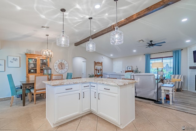 kitchen with ceiling fan, arched walkways, light tile patterned floors, beamed ceiling, and visible vents