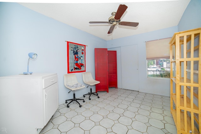 living area with light floors and ceiling fan