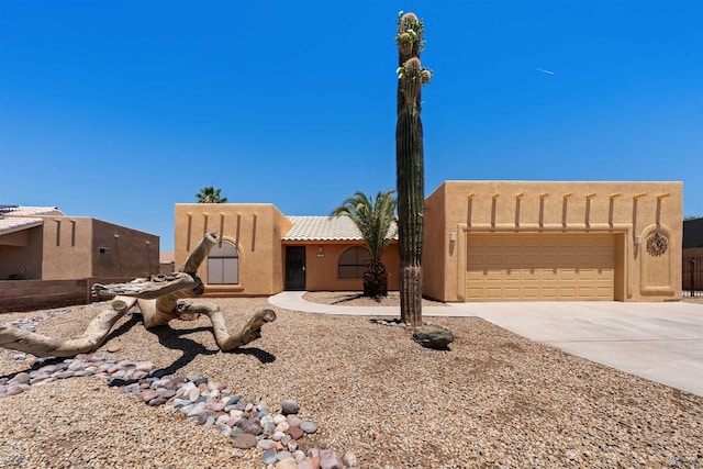 11212 E 37th Ln, Yuma, AZ 85367 - adobe home featuring driveway, an attached garage, and stucco siding
