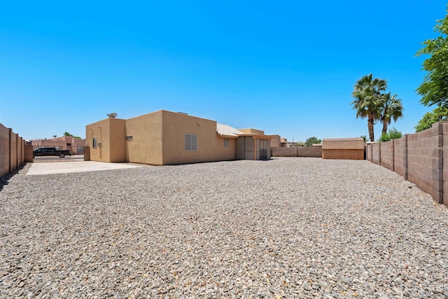 11212 E 37th Ln, Yuma, AZ 85367 - back of house featuring stucco siding, a fenced backyard, and a patio area