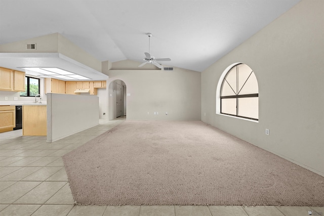 11212 E 37th Ln, Yuma, AZ 85367 - unfurnished living room featuring ceiling fan, vaulted ceiling, arched walkways, a sink, and light tile patterned flooring