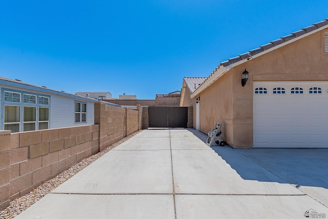 10237 S Monsoon Ave, Yuma, AZ 85365 - view of property exterior with stucco siding, a tile roof, and concrete driveway