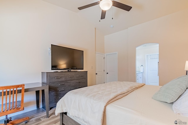 10237 S Monsoon Ave, Yuma, AZ 85365 - bedroom featuring arched walkways, light wood-type flooring, lofted ceiling, connected bathroom, and a ceiling fan