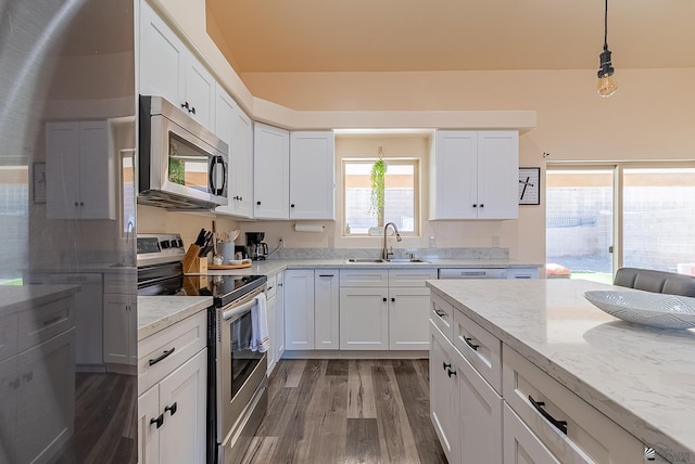 10237 S Monsoon Ave, Yuma, AZ 85365 - kitchen with stainless steel appliances, wood finished floors, white cabinets, and light stone countertops