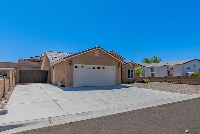 10237 S Monsoon Ave, Yuma, AZ 85365 - single story home with a garage, a tiled roof, concrete driveway, and stucco siding