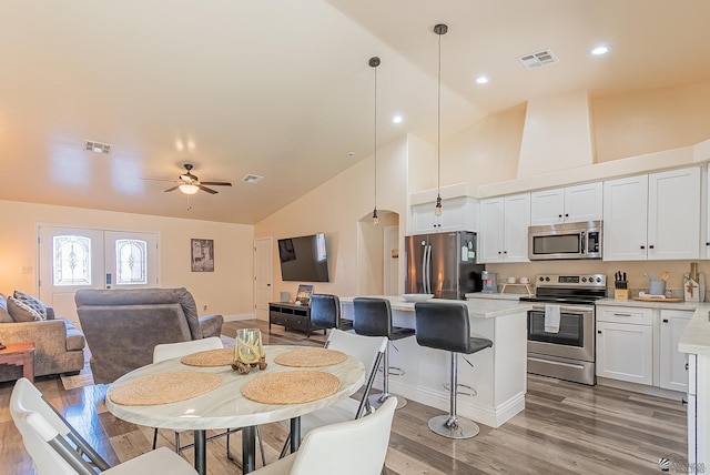 10237 S Monsoon Ave, Yuma, AZ 85365 - dining room featuring high vaulted ceiling, light wood-style floors, ceiling fan, and recessed lighting
