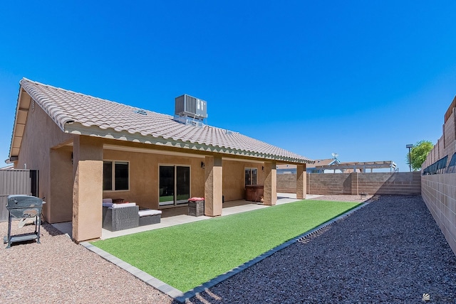 10237 S Monsoon Ave, Yuma, AZ 85365 - back of property featuring a tile roof, stucco siding, a fenced backyard, and a patio area