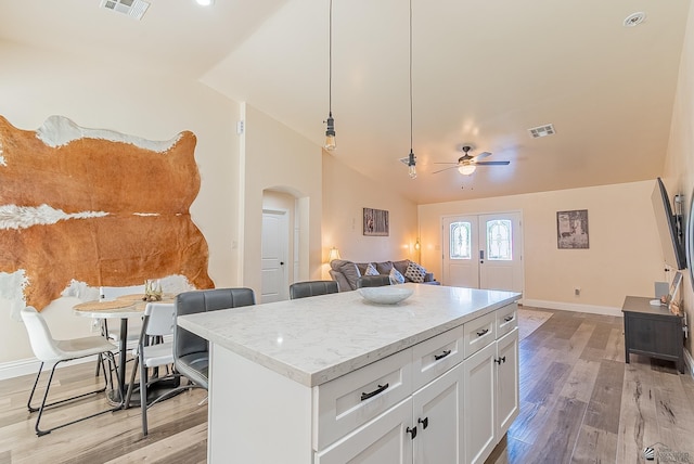 10237 S Monsoon Ave, Yuma, AZ 85365 - kitchen with arched walkways, lofted ceiling, light wood finished floors, ceiling fan, and open floor plan