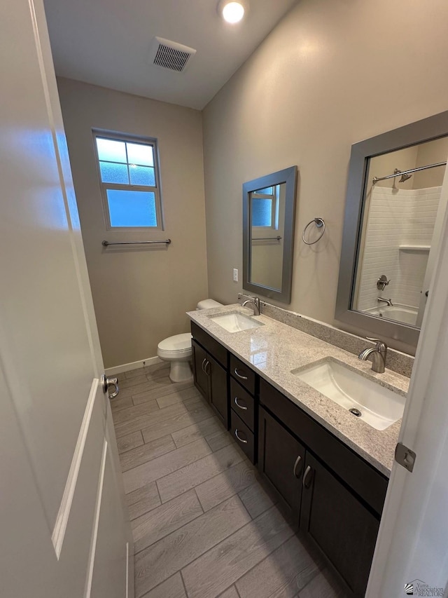 14701 E 42nd St, Yuma, AZ 85367 - full bathroom with visible vents, a sink, toilet, and wood tiled floor