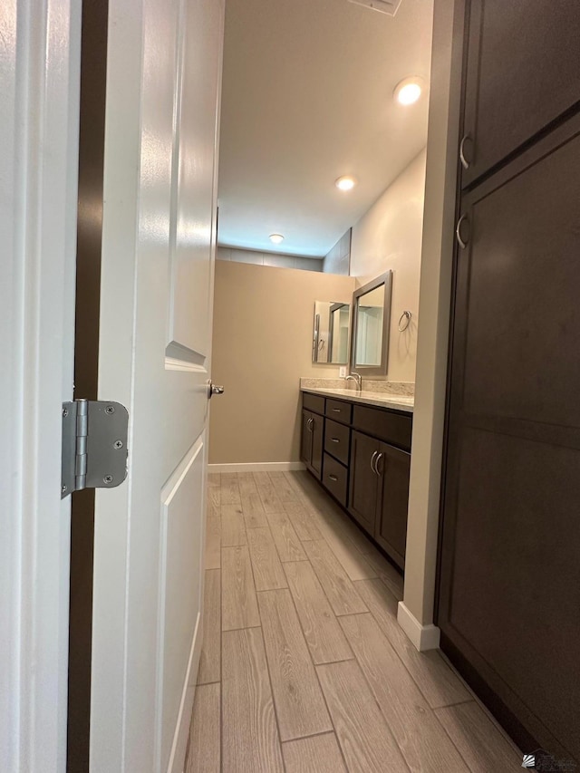 14701 E 42nd St, Yuma, AZ 85367 - bathroom featuring recessed lighting, baseboards, wood finished floors, and vanity