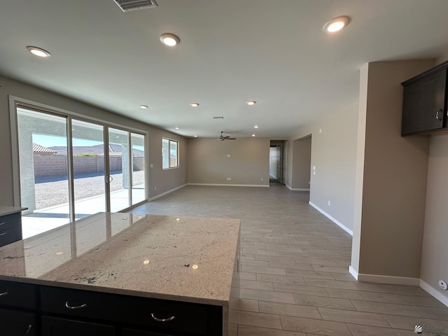 14701 E 42nd St, Yuma, AZ 85367 - kitchen featuring visible vents, light wood-type flooring, baseboards, light stone counters, and recessed lighting