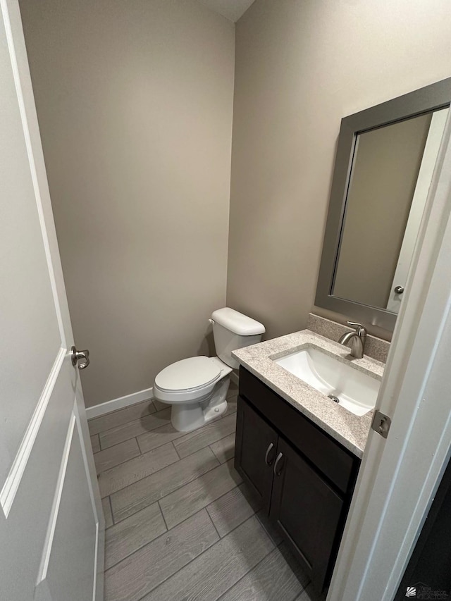 14701 E 42nd St, Yuma, AZ 85367 - half bathroom featuring toilet, wood finish floors, and vanity