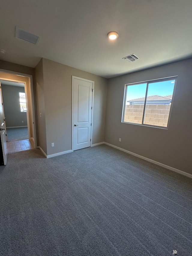14701 E 42nd St, Yuma, AZ 85367 - unfurnished bedroom featuring carpet floors, baseboards, visible vents, and multiple windows