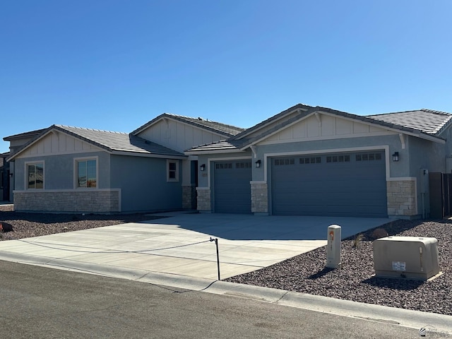 14701 E 42nd St, Yuma, AZ 85367 - view of front of property with a garage, board and batten siding, a tiled roof, and stone siding
