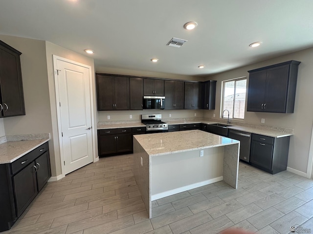 14701 E 42nd St, Yuma, AZ 85367 - kitchen featuring visible vents, wood tiled floor, appliances with stainless steel finishes, and a kitchen island
