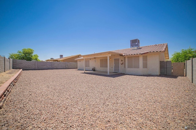 11250 E 25th Pl, Yuma, AZ 85367 - back of house featuring a tiled roof, stucco siding, a chimney, central AC, and a fenced backyard