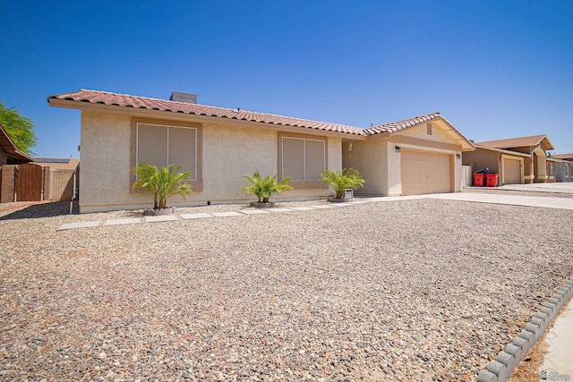 11250 E 25th Pl, Yuma, AZ 85367 - view of front facade featuring stucco siding, concrete driveway, an attached garage, and a tiled roof