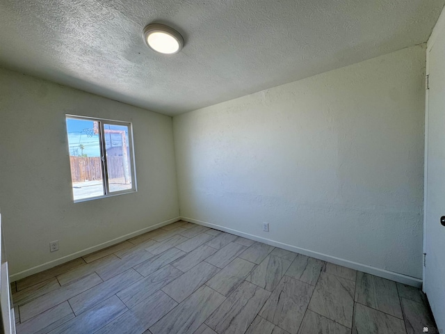 2039 S 11th Ave, Yuma, AZ 85364 - empty room featuring a textured ceiling and baseboards