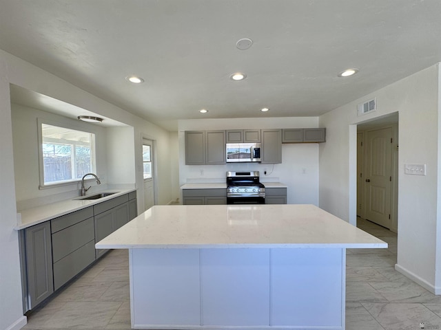 2039 S 11th Ave, Yuma, AZ 85364 - kitchen featuring stainless steel appliances, gray cabinets, a sink, light marble finish floors, and recessed lighting