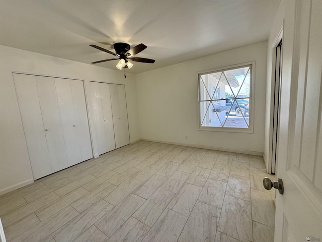 2039 S 11th Ave, Yuma, AZ 85364 - unfurnished bedroom with multiple closets, ceiling fan, and light wood-type flooring