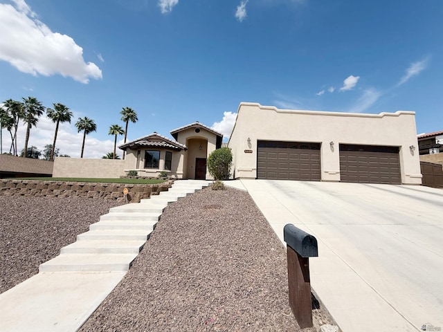 view of front of property with concrete driveway, stucco siding, and an attached garage