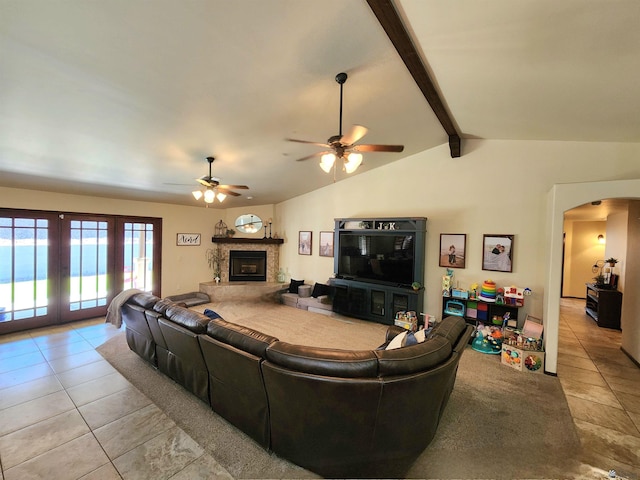 1404 W Parkway Dr, Yuma, AZ 85364 - living area featuring french doors, light tile patterned floors, arched walkways, ceiling fan, and a fireplace