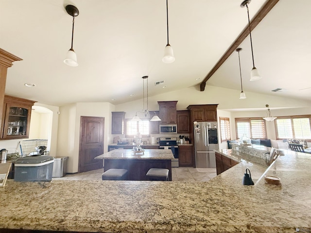 kitchen with stainless steel appliances, plenty of natural light, a spacious island, and visible vents
