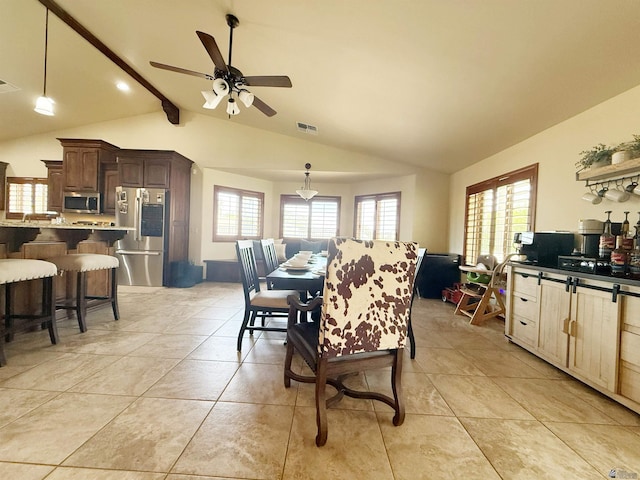 dining space with visible vents, light tile patterned flooring, ceiling fan, and vaulted ceiling with beams