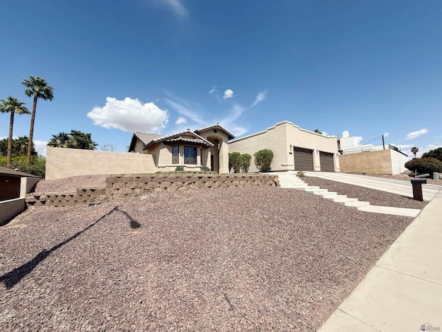 view of front facade with concrete driveway, stucco siding, and an attached garage