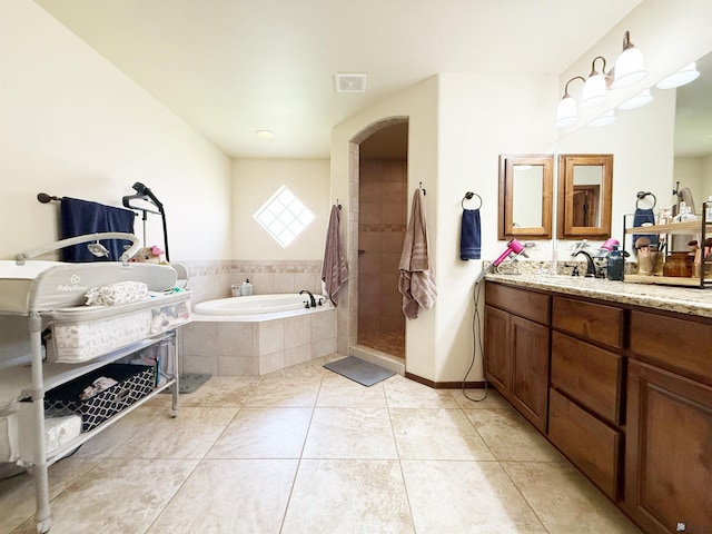 bathroom featuring a bath, vanity, visible vents, tile patterned floors, and tiled shower