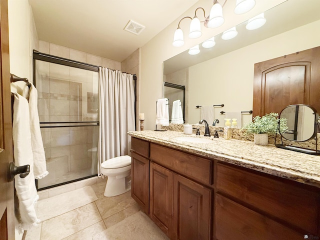full bath featuring toilet, vanity, visible vents, a stall shower, and tile patterned flooring