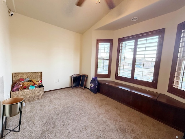 interior space featuring plenty of natural light, lofted ceiling, ceiling fan, and carpet floors