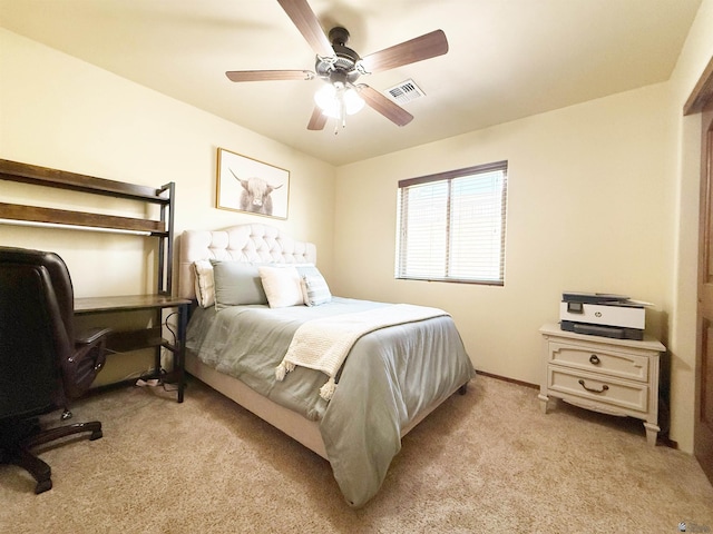 bedroom with a ceiling fan, baseboards, visible vents, and light colored carpet