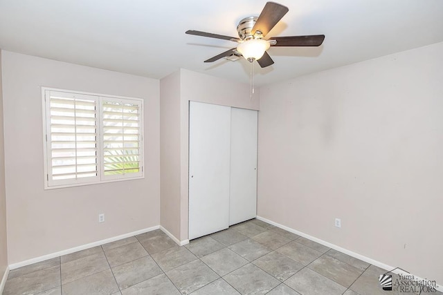 1508 W 14th St, Yuma, AZ 85364 - unfurnished bedroom with a closet, baseboards, a ceiling fan, and light tile patterned floors