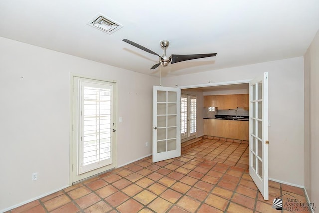1508 W 14th St, Yuma, AZ 85364 - unfurnished room featuring french doors, a ceiling fan, a sink, and baseboards