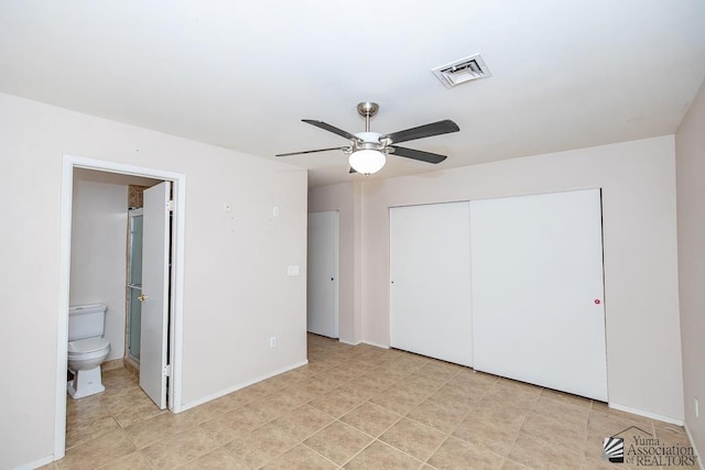1508 W 14th St, Yuma, AZ 85364 - unfurnished bedroom with a closet, ensuite bathroom, a ceiling fan, and baseboards