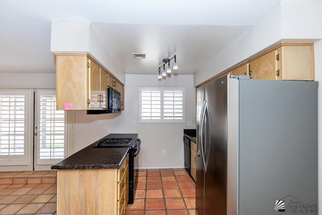 1508 W 14th St, Yuma, AZ 85364 - kitchen with black appliances, light brown cabinetry, light tile patterned floors, dark stone countertops, and rail lighting