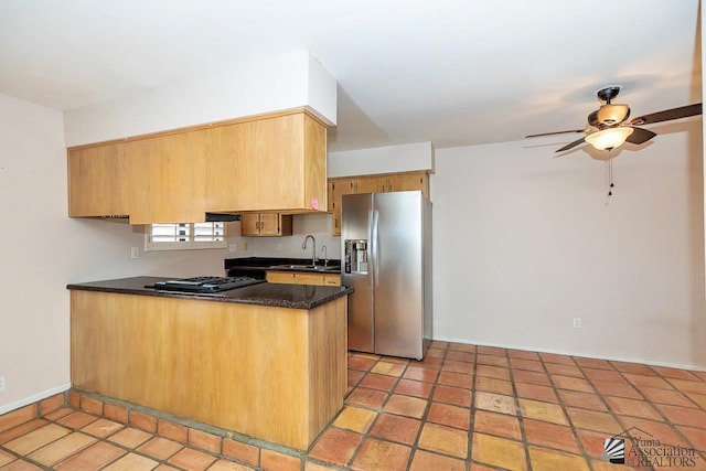 1508 W 14th St, Yuma, AZ 85364 - kitchen featuring stainless steel fridge with ice dispenser, a sink, a peninsula, a ceiling fan, and baseboards